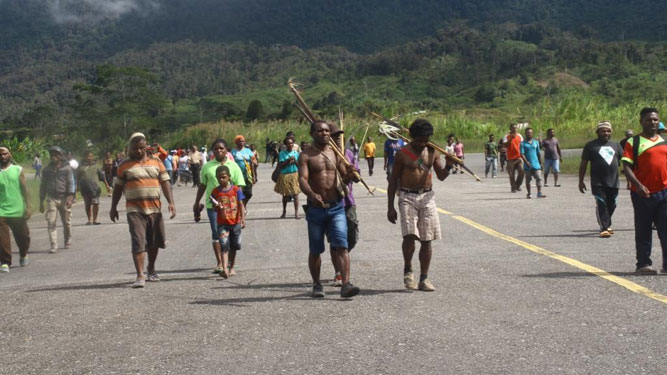 Ribuan warga saat melakukan aksi damai dengan memenuhi runway bandara Oksibil, Jumat (11/5/2018)