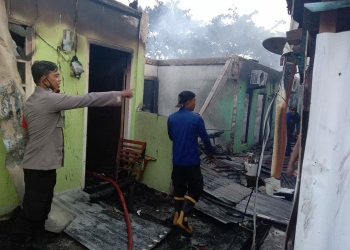 Aparat kepolisian bersama petugas kebakaran ketika berusaha memadamkan api.(Hans Palen/Nokenlive.com)